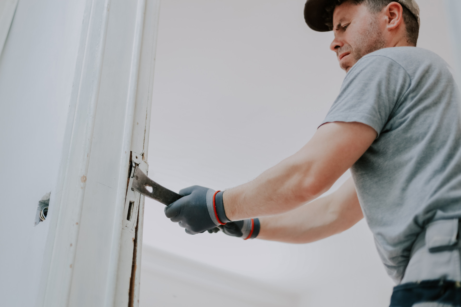 hands-man-working-with-crowbar-indoors