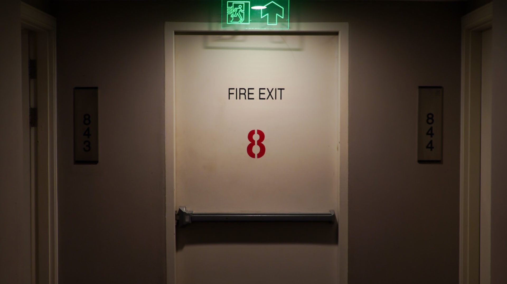 emergency-exit-sign-hotel-room-with-green-light-emergency-exit-sign